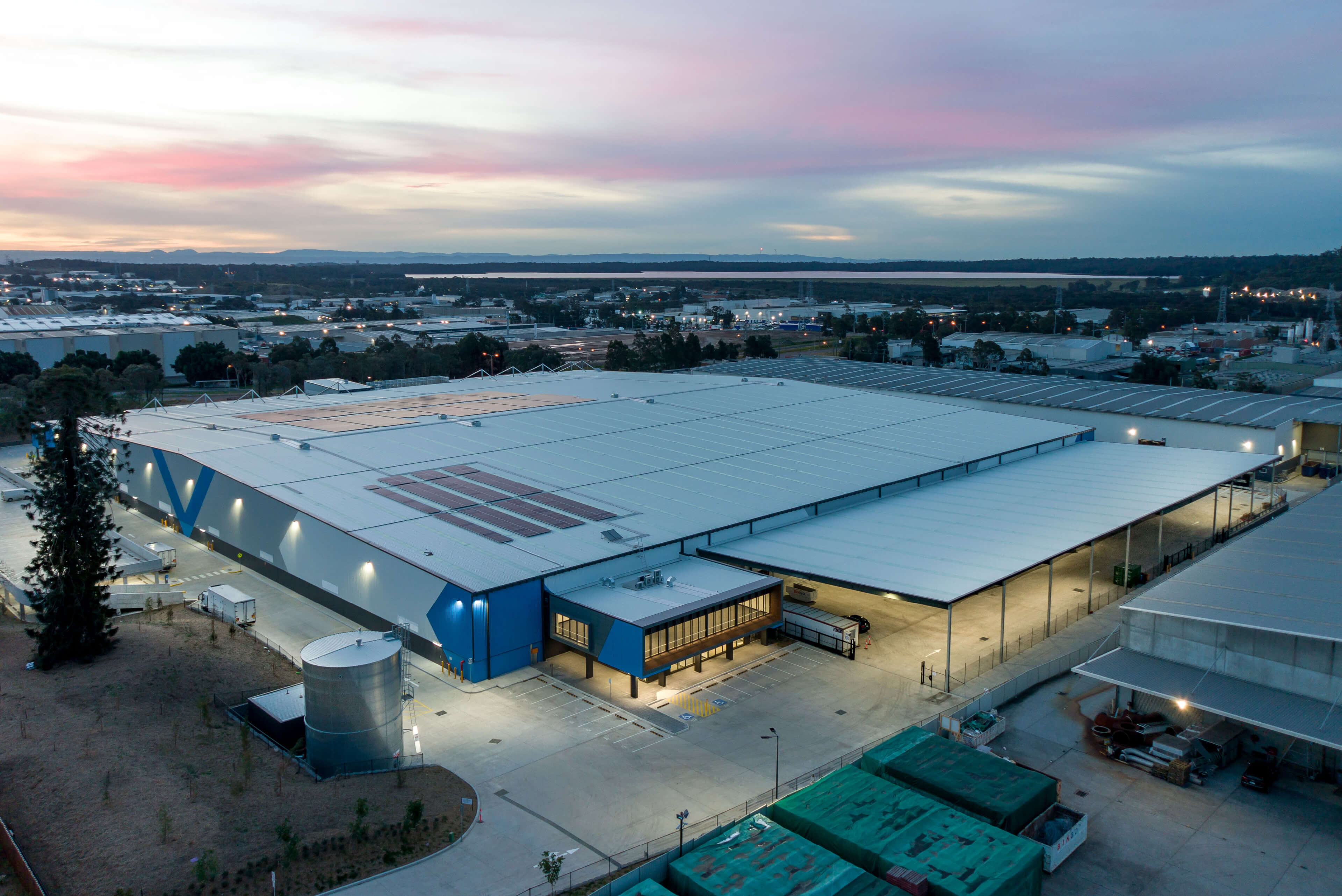 1 hero birds eye view of full site with red sunset of building 2 wetherill park taylor construction industrial