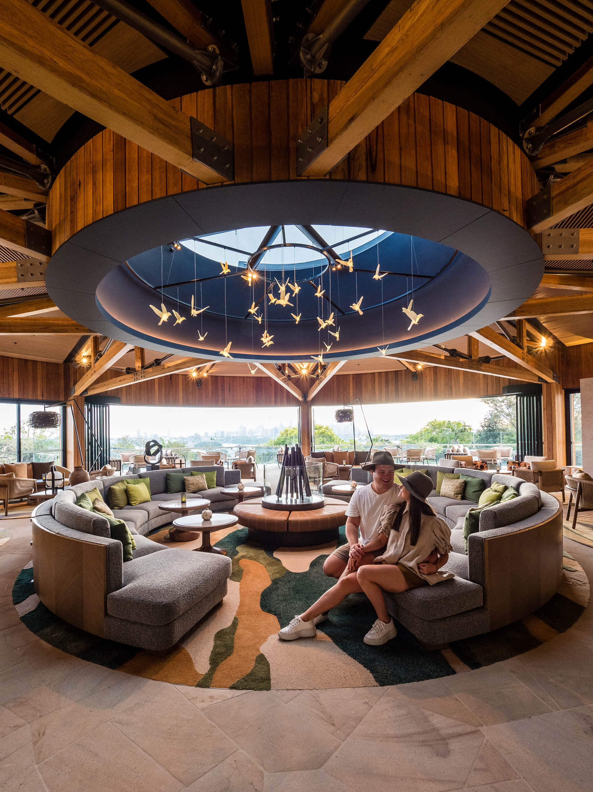 4 couple sitting in central seating feature within reception lounge at taronga wildlife retreat sydney taylor construction hospitality