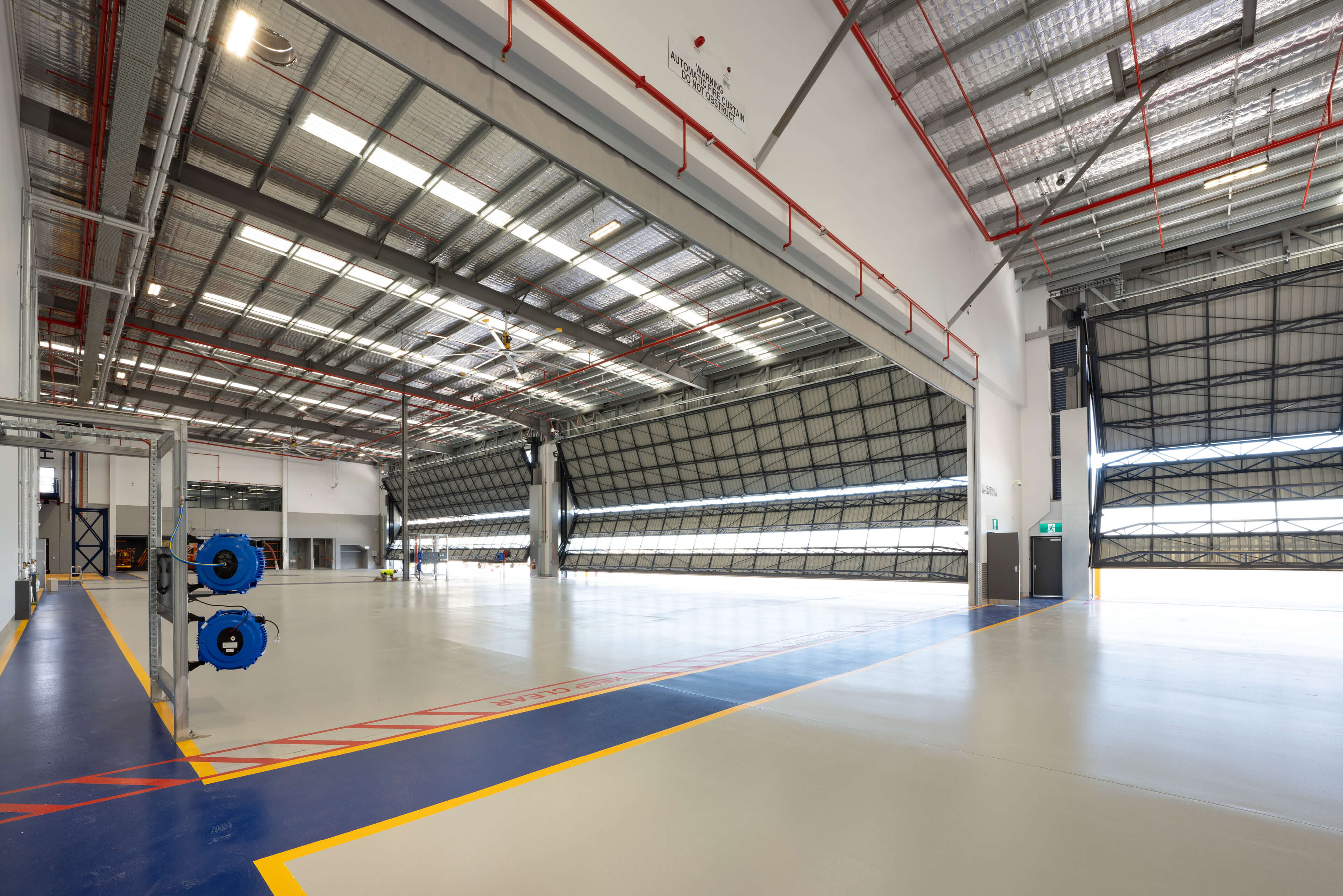9 interior view of hangar bays with blue floor markings for fixed wing operation at polair facility bankstown taylor construction refurbishment and live environments