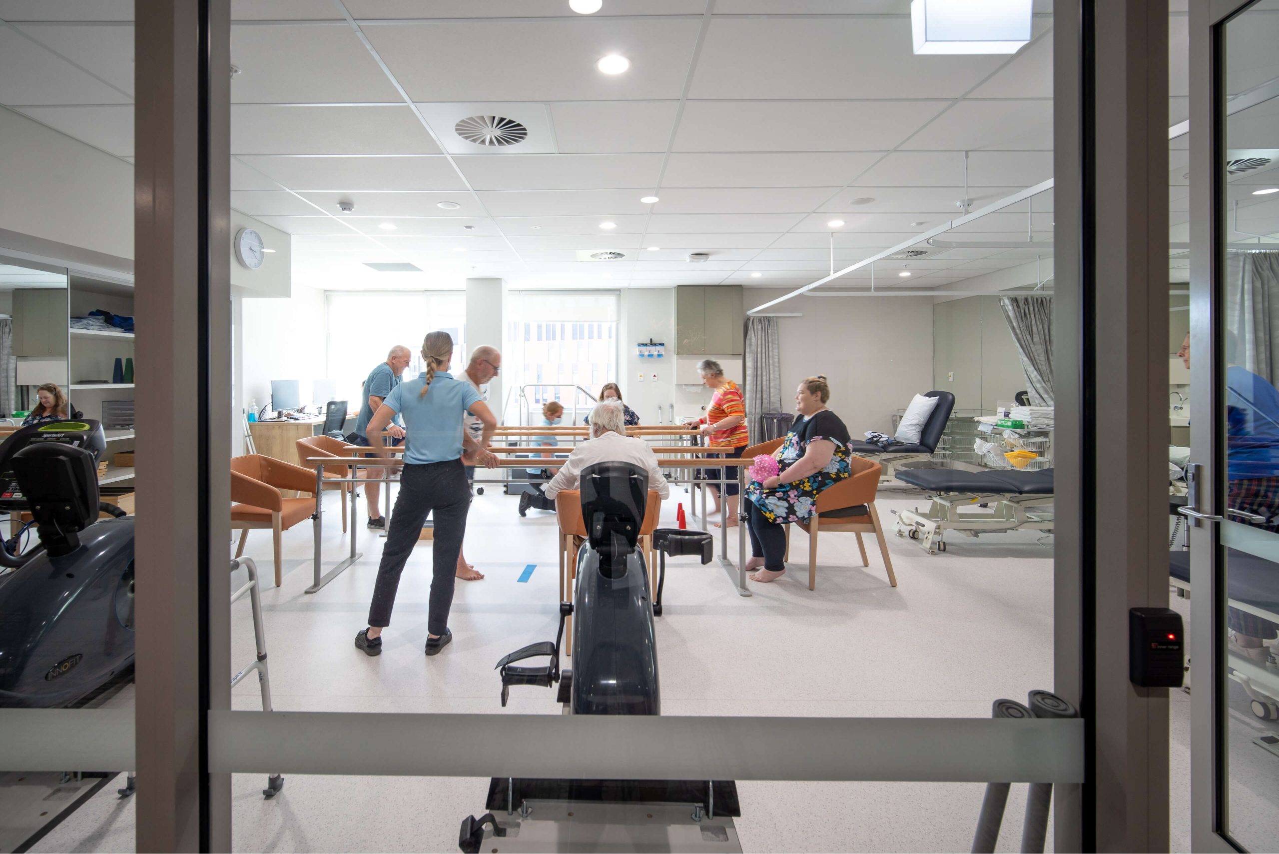 006 physiotherapists and patients in exercise therapy room with equipment and beds matilda nepean private hospital taylor