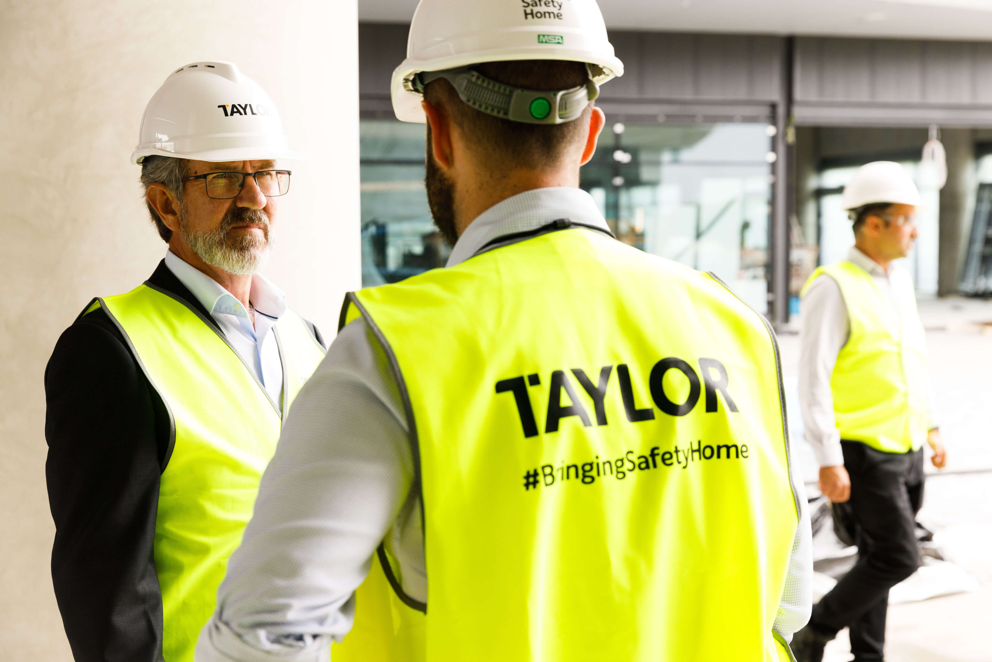 2 clive in discussion with taylor team onsite taylor construction photography bringing safety home