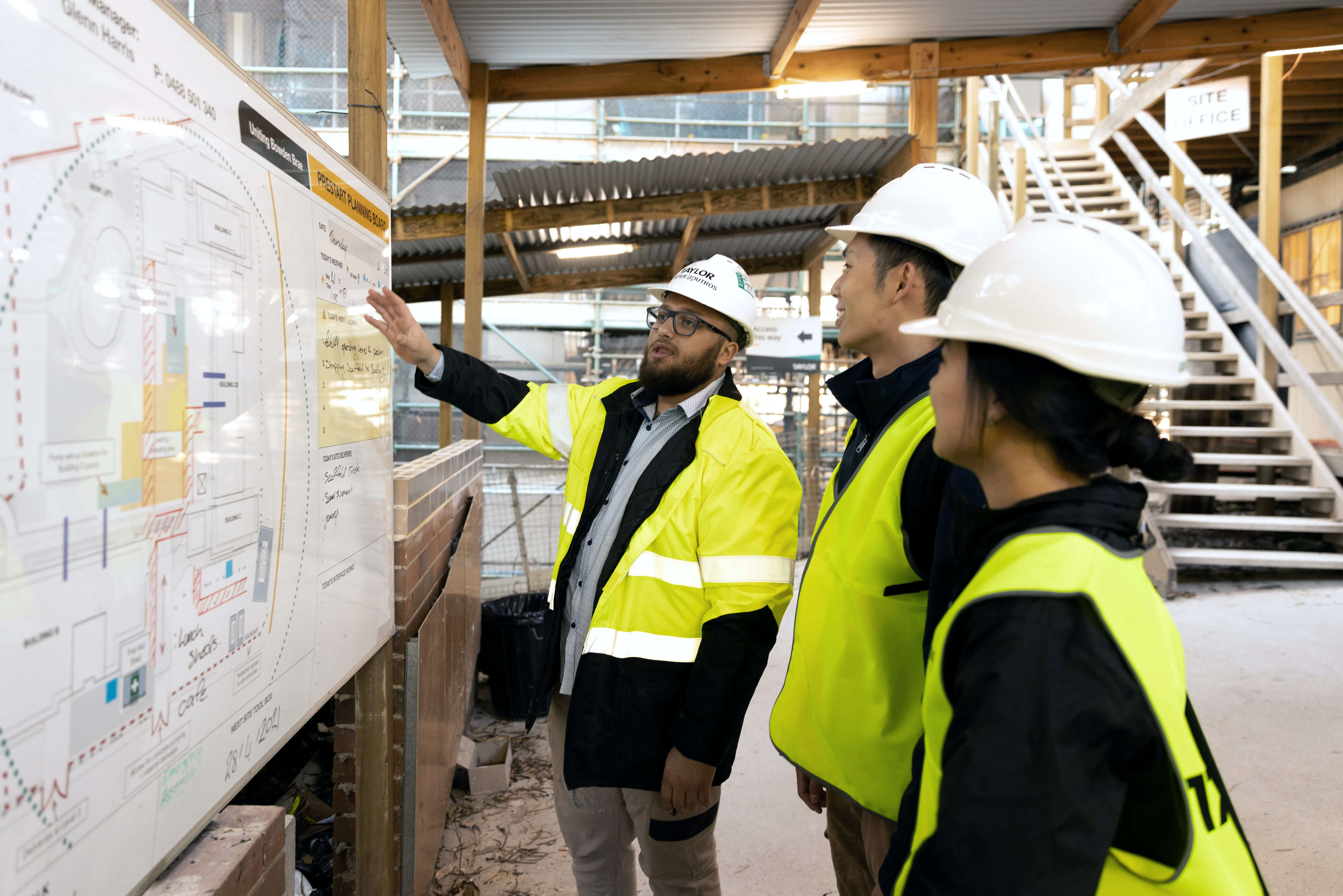 7 mentoring two students onsite with site manager taylor construction photography 2