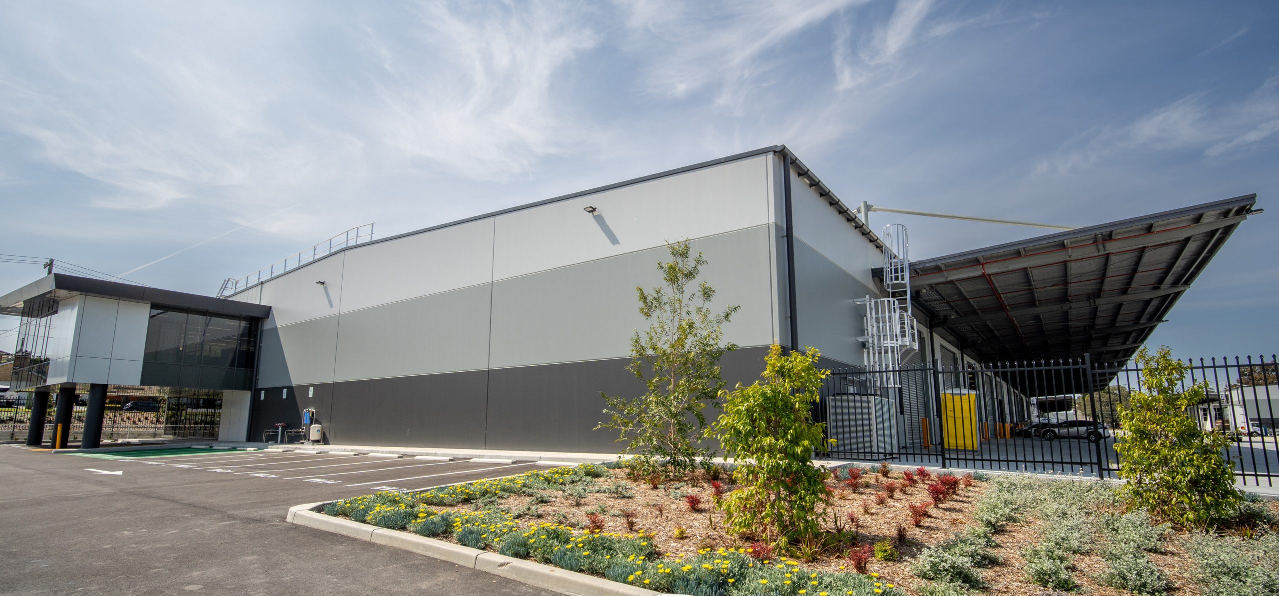 2 warehouse exterior with carpark and plants 430 marion industrial park bankstown airport taylor construction industrial